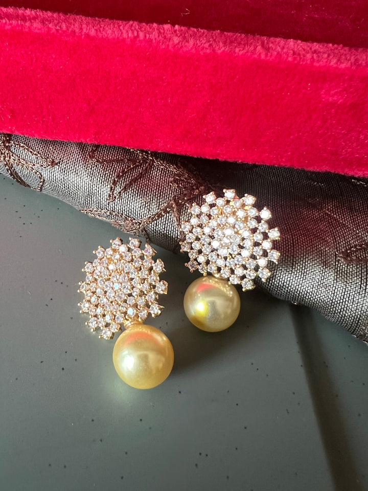 Sparkling CZ Sunburst Stud Earrings with Golden Pearl Drop