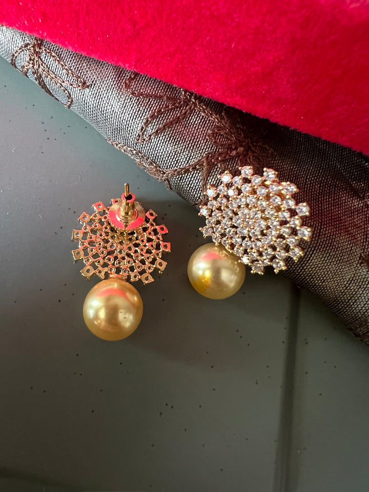 Sparkling CZ Sunburst Stud Earrings with Golden Pearl Drop